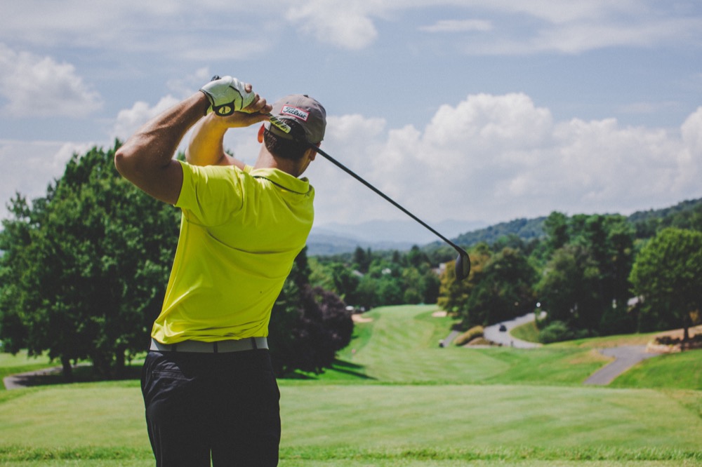 Golfer swinging golf club