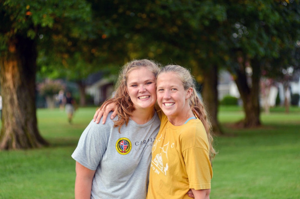 Two female students posing for photo outside