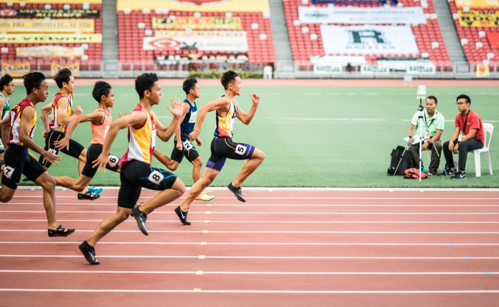 Runners crossing a finish line at a race