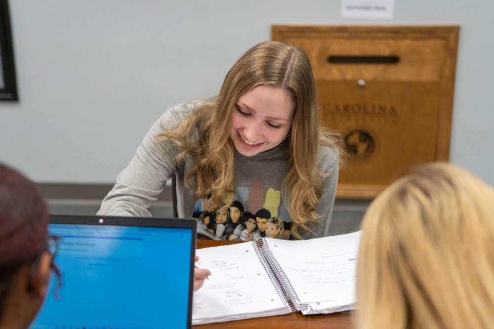 Female college student writing in notebook