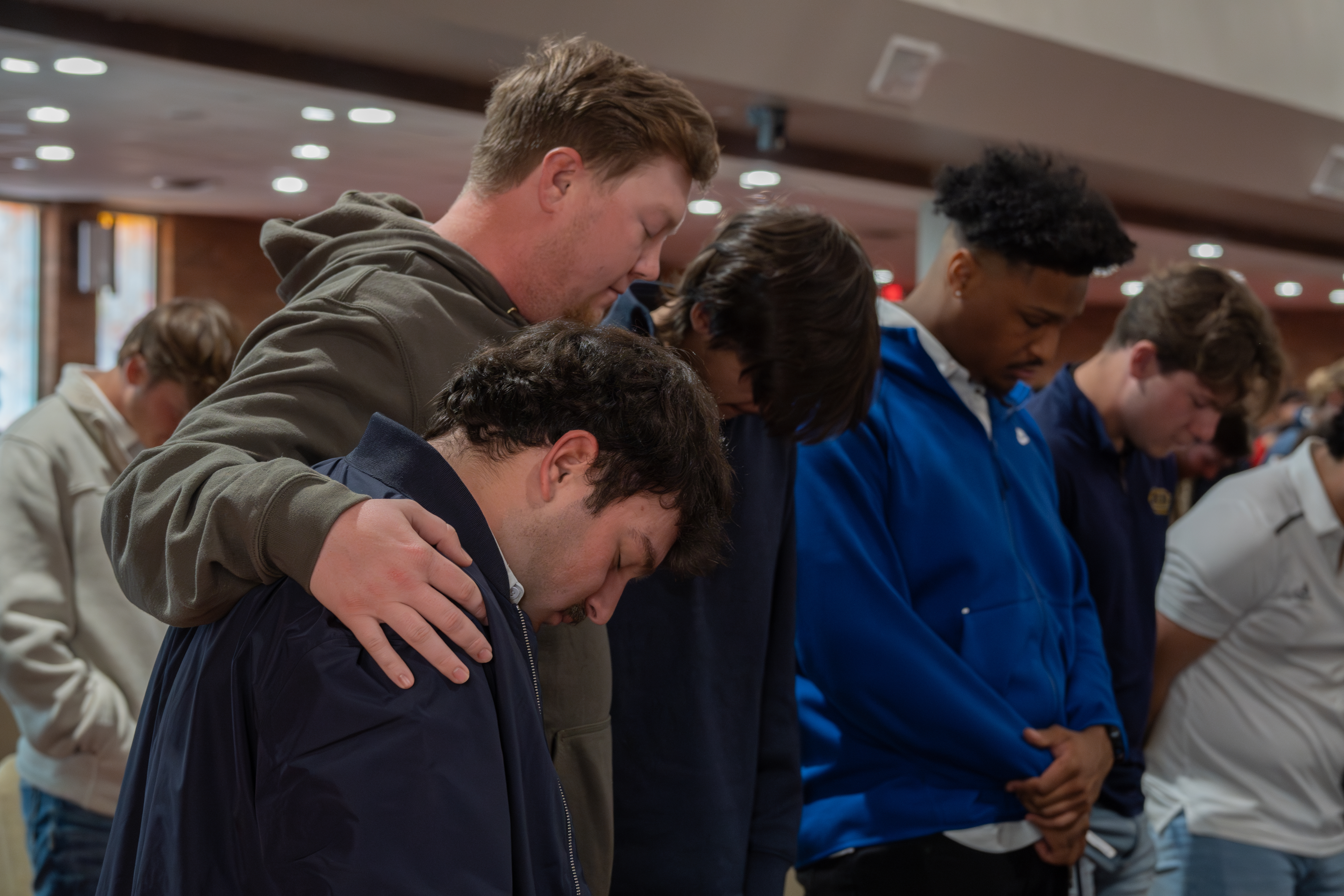 male students praying together